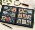 Stockbook, fictional stamps, magnifier, stamp tongs, and archival supplies on a collector's table
